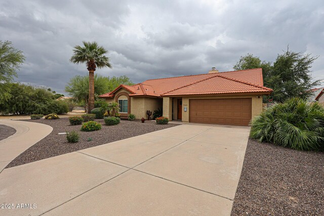 9085 E Windrose Dr, Scottsdale, AZ 85260 - mediterranean / spanish-style home with a tiled roof, a garage, stucco siding, concrete driveway, and a chimney