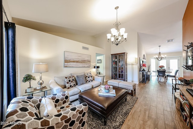 9085 E Windrose Dr, Scottsdale, AZ 85260 - living area featuring a chandelier, wood finished floors, and lofted ceiling