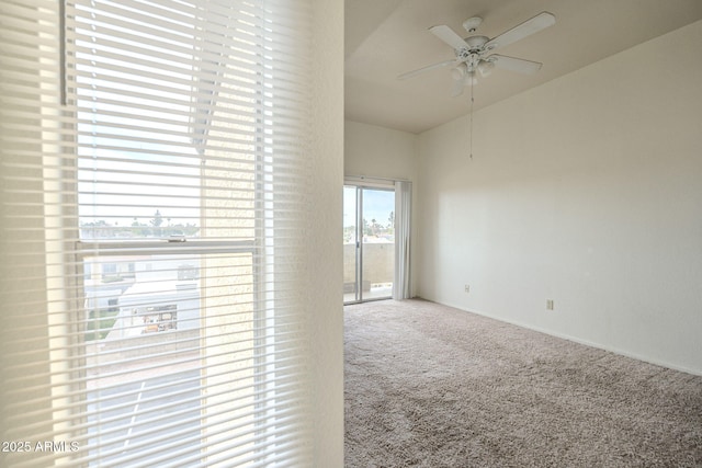 carpeted empty room featuring a ceiling fan