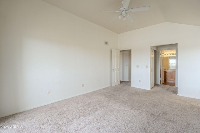 unfurnished bedroom with lofted ceiling, light carpet, visible vents, and ensuite bath