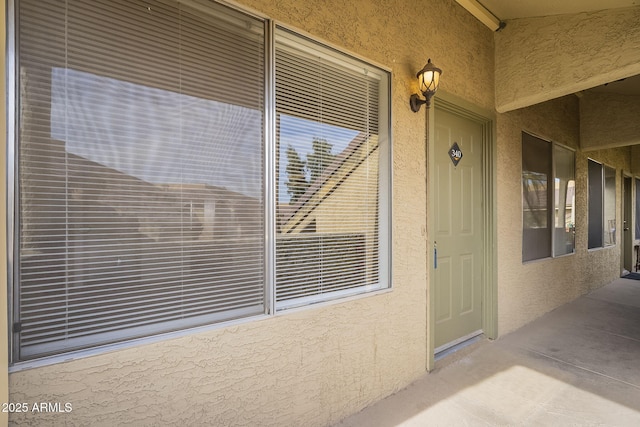 entrance to property with stucco siding