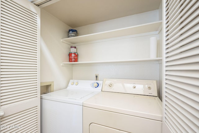 clothes washing area featuring washing machine and dryer and laundry area