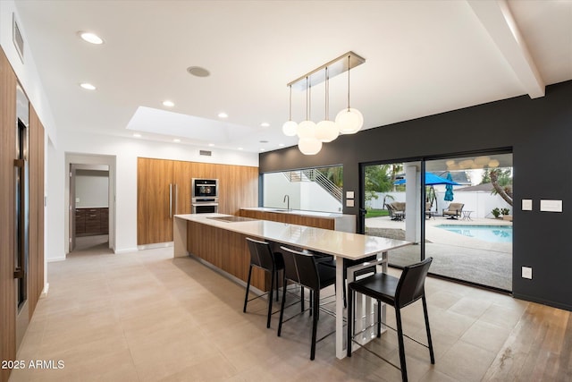 dining room with beamed ceiling, a skylight, visible vents, and recessed lighting