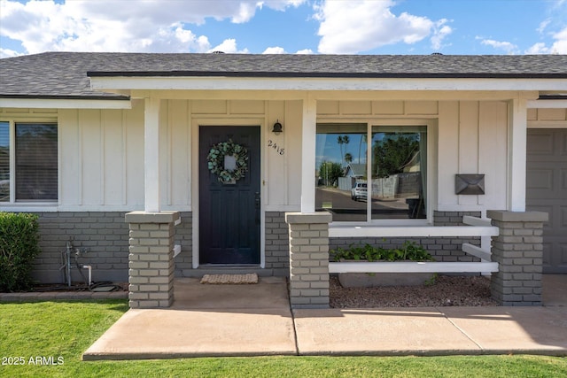 2418 E Hermosa Dr, Tempe, AZ 85282 - property entrance with board and batten siding, brick siding, and a shingled roof