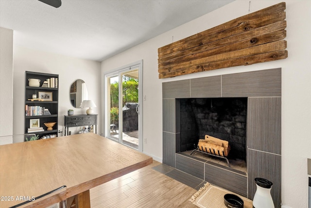 2418 E Hermosa Dr, Tempe, AZ 85282 - living room featuring wood finished floors, a tiled fireplace, and baseboards