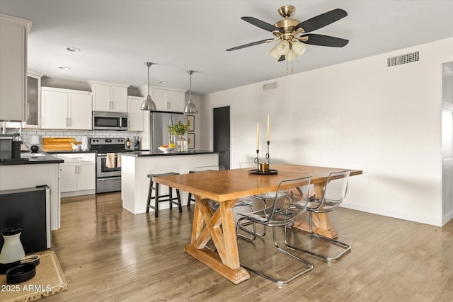 2418 E Hermosa Dr, Tempe, AZ 85282 - dining area featuring ceiling fan, wood finished floors, baseboards, and recessed lighting
