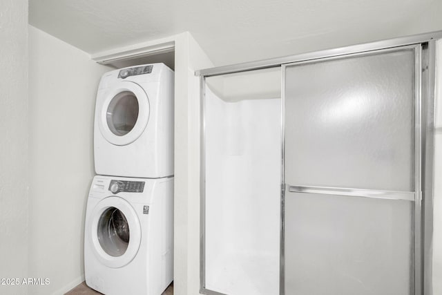 laundry area with laundry area and stacked washer and clothes dryer