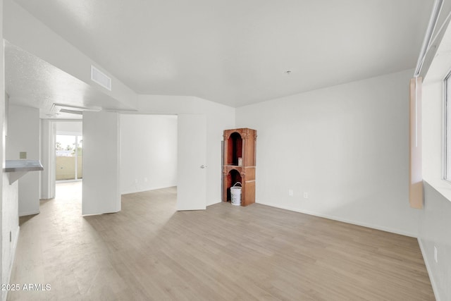 unfurnished room with visible vents and light wood-type flooring