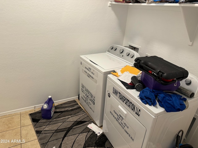 laundry area with washer hookup, washing machine and clothes dryer, and light tile floors