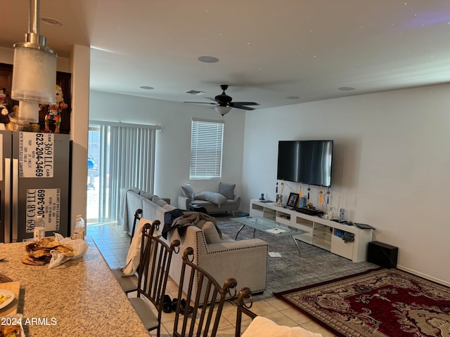 tiled living room with ceiling fan