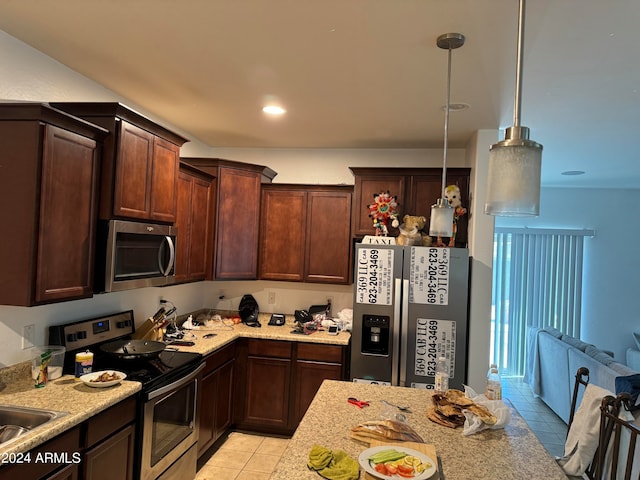 kitchen featuring dark brown cabinetry, stainless steel appliances, light tile flooring, and decorative light fixtures