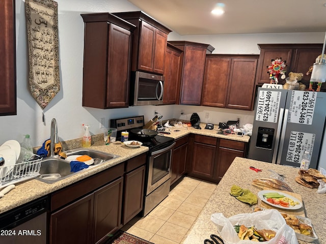 kitchen featuring sink, appliances with stainless steel finishes, and light tile flooring