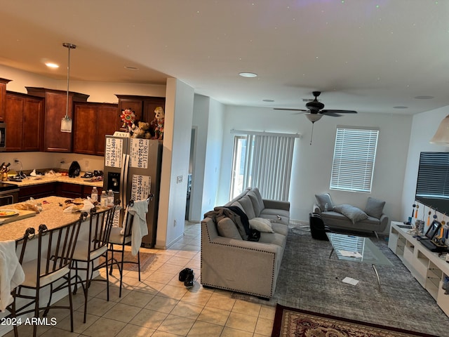 living room with ceiling fan and light tile flooring