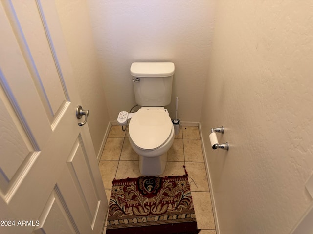 bathroom featuring toilet and tile flooring