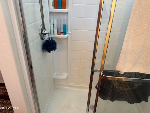 bathroom with a shower with shower door