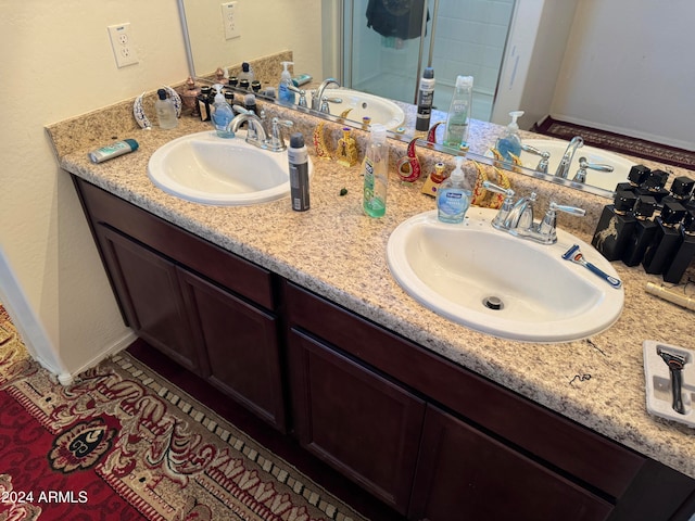 bathroom featuring vanity with extensive cabinet space and dual sinks