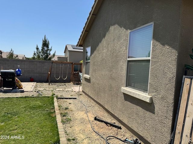 view of property exterior featuring a lawn