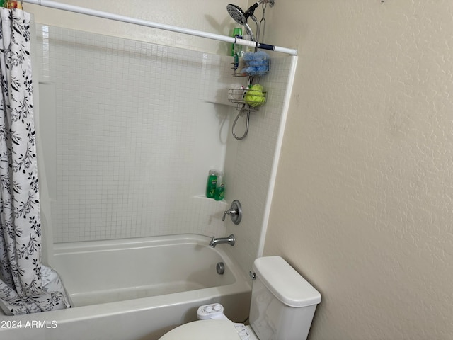 bathroom with toilet and shower / bath combo with shower curtain