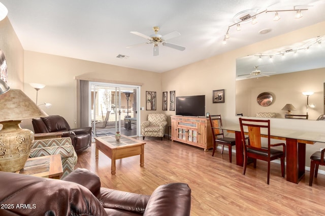 living room with light hardwood / wood-style floors and ceiling fan