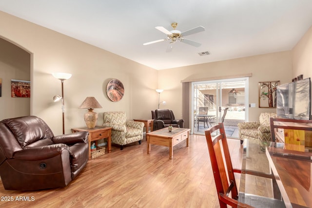 living room with ceiling fan and light hardwood / wood-style flooring