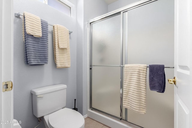 bathroom featuring toilet and an enclosed shower