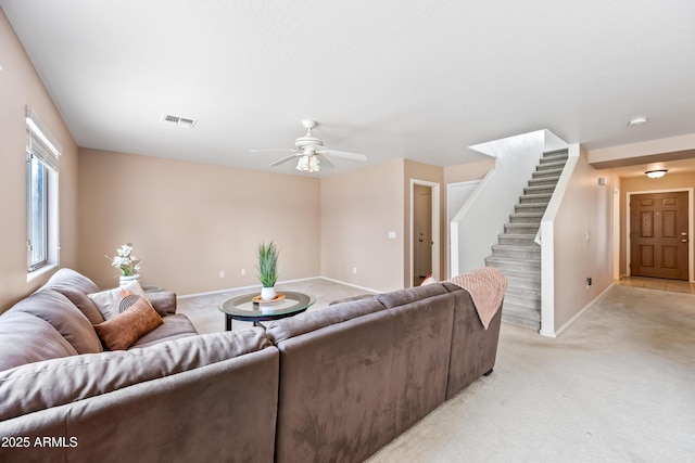 2327 E Meadow Creek Way, San Tan Valley, AZ 85140 - living area featuring stairway, light colored carpet, a ceiling fan, and baseboards