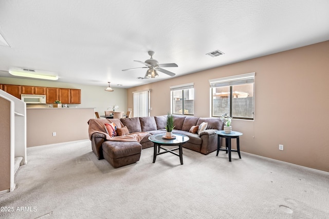 2327 E Meadow Creek Way, San Tan Valley, AZ 85140 - living room featuring light colored carpet, a ceiling fan, and baseboards