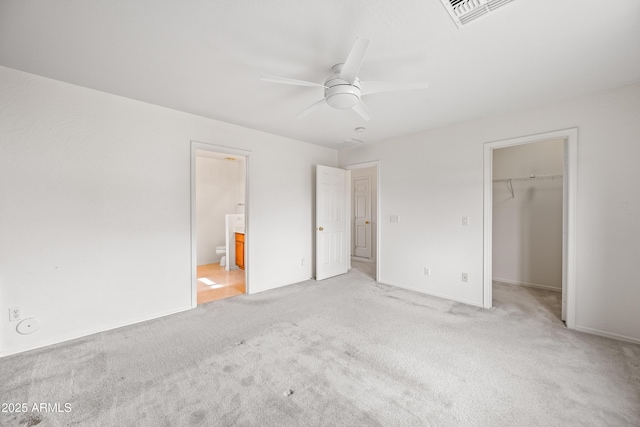 2327 E Meadow Creek Way, San Tan Valley, AZ 85140 - unfurnished bedroom with a spacious closet, light colored carpet, a closet, and ensuite bathroom