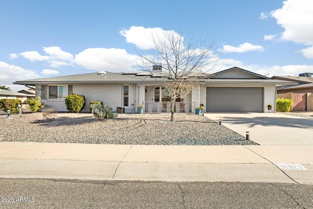 ranch-style house featuring solar panels and a garage