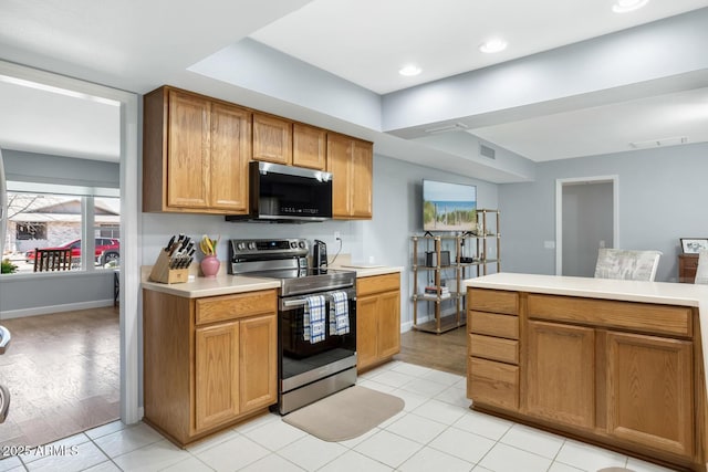 kitchen featuring light tile patterned floors and stainless steel appliances