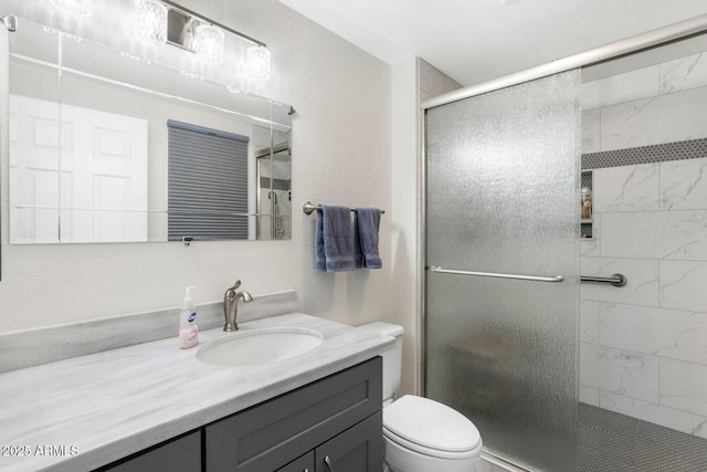 bathroom featuring walk in shower, vanity, and toilet