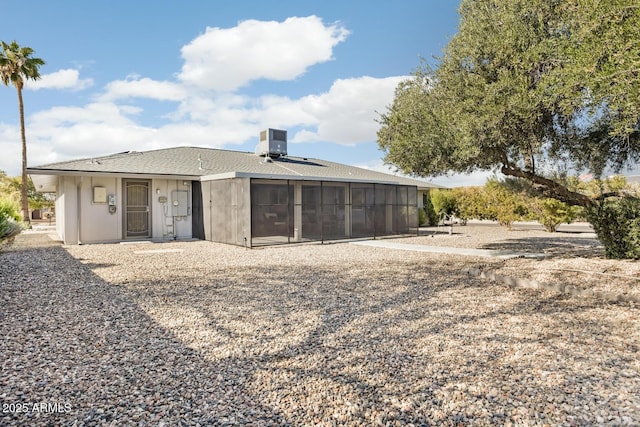 rear view of house with a sunroom and cooling unit