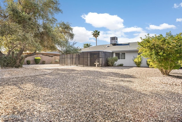 view of yard featuring cooling unit and a sunroom