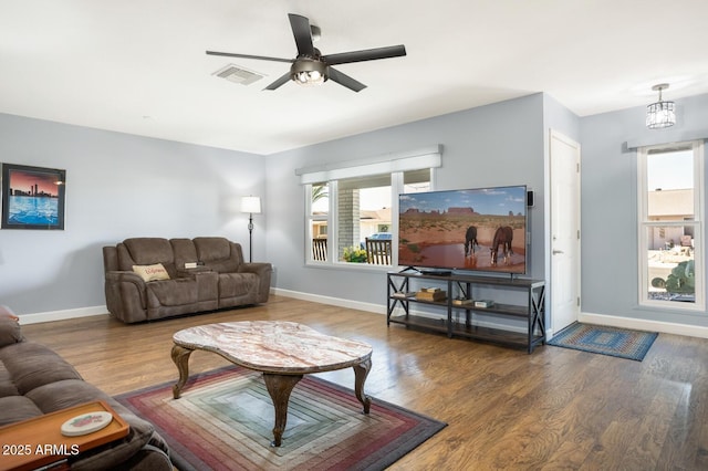 living room with ceiling fan with notable chandelier and wood-type flooring