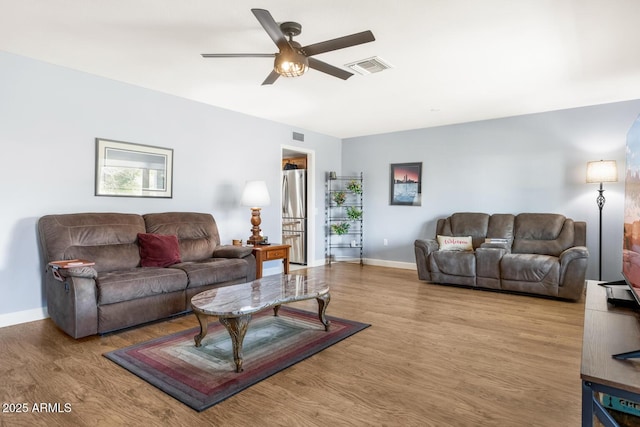 living room featuring light wood-type flooring and ceiling fan