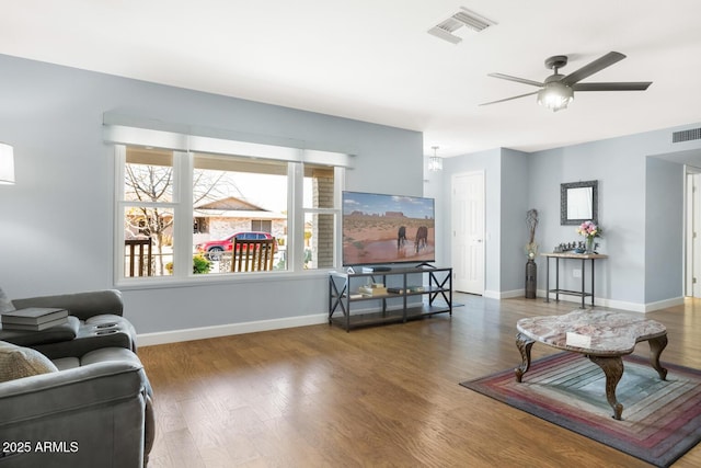 living room featuring ceiling fan and hardwood / wood-style floors