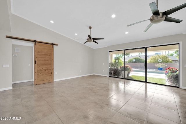 unfurnished room featuring ceiling fan, lofted ceiling, ornamental molding, and a barn door