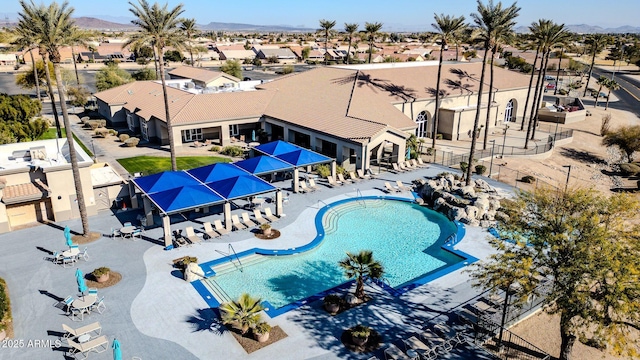 view of swimming pool with a mountain view and a patio