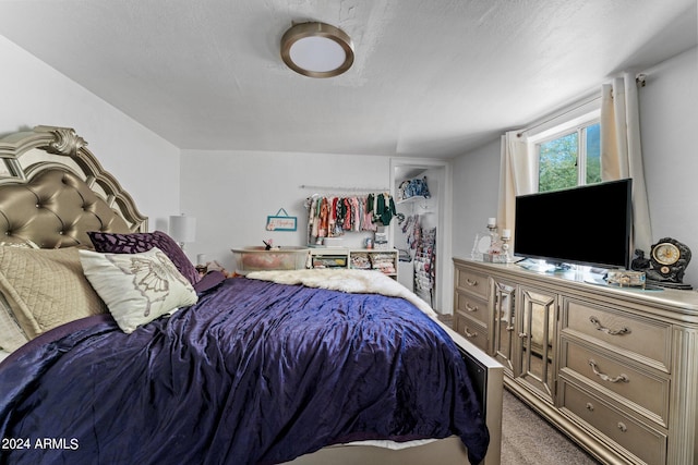 bedroom with dark colored carpet