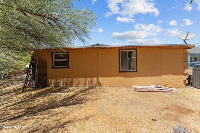 back of property with central AC