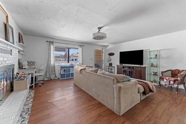 living room with a fireplace and hardwood / wood-style floors