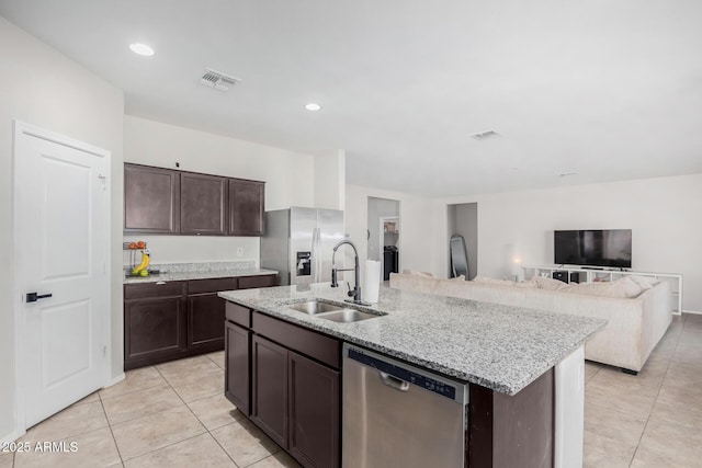 kitchen featuring stainless steel appliances, a sink, visible vents, dark brown cabinets, and an island with sink