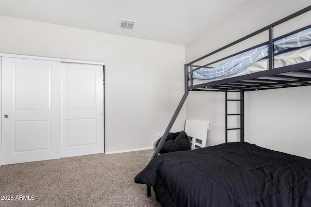 bedroom with carpet floors, a closet, and visible vents