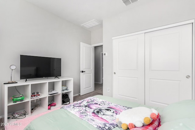 bedroom with carpet floors, a closet, visible vents, and baseboards