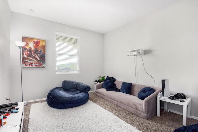 living area featuring baseboards and carpet flooring