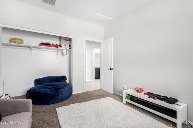 living area with carpet flooring, visible vents, and baseboards