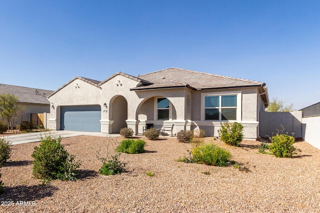 view of front of property with a garage, driveway, a tiled roof, and stucco siding