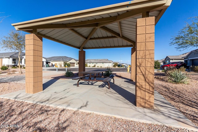 view of patio / terrace featuring a gazebo and a residential view