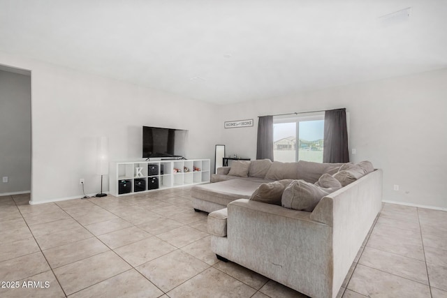 living area with light tile patterned flooring and baseboards