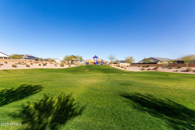 view of yard featuring fence and playground community